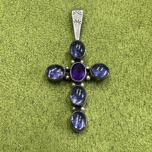 Sterling silver cross with amethyst crystals.